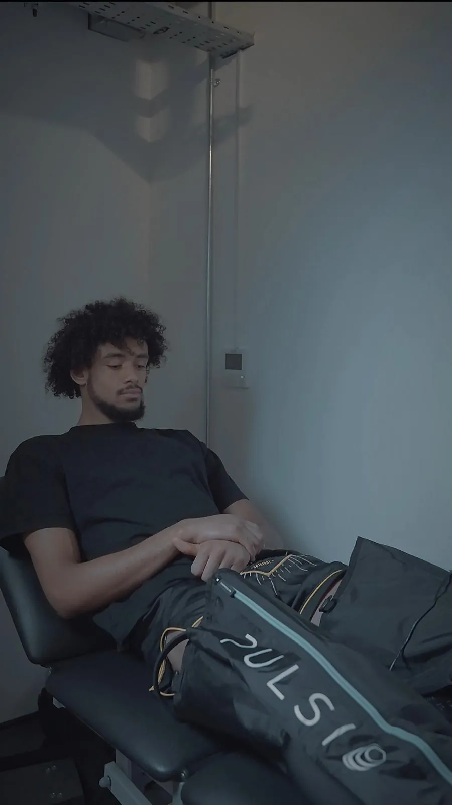 Athlete relaxing in leg compression boots